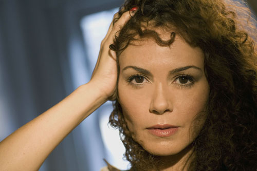 Actress Lauren B Martin with her hair swept to the side, looking directly at the camera